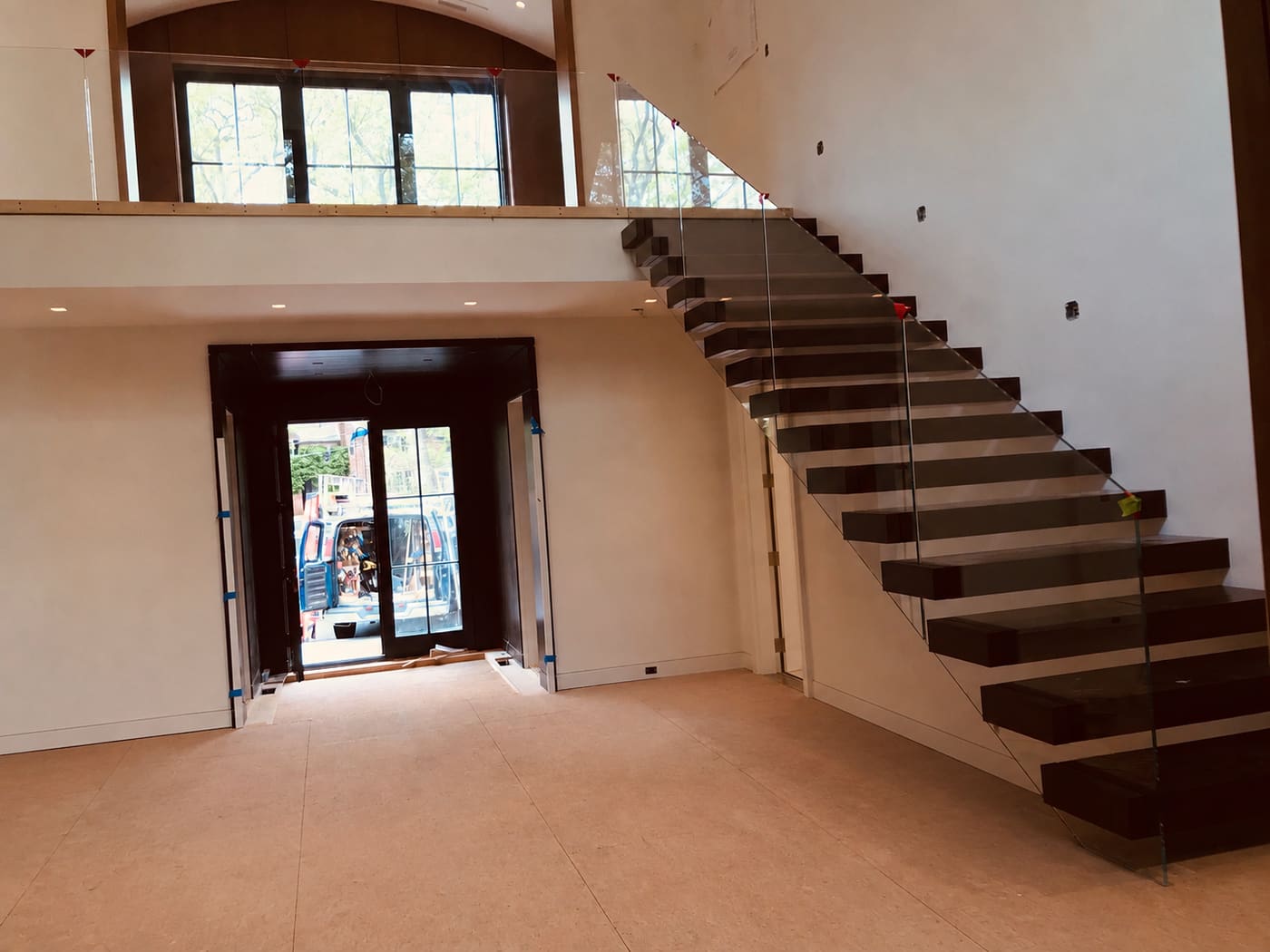 Frameless glass staircase railing in a luxury Rhode Island home