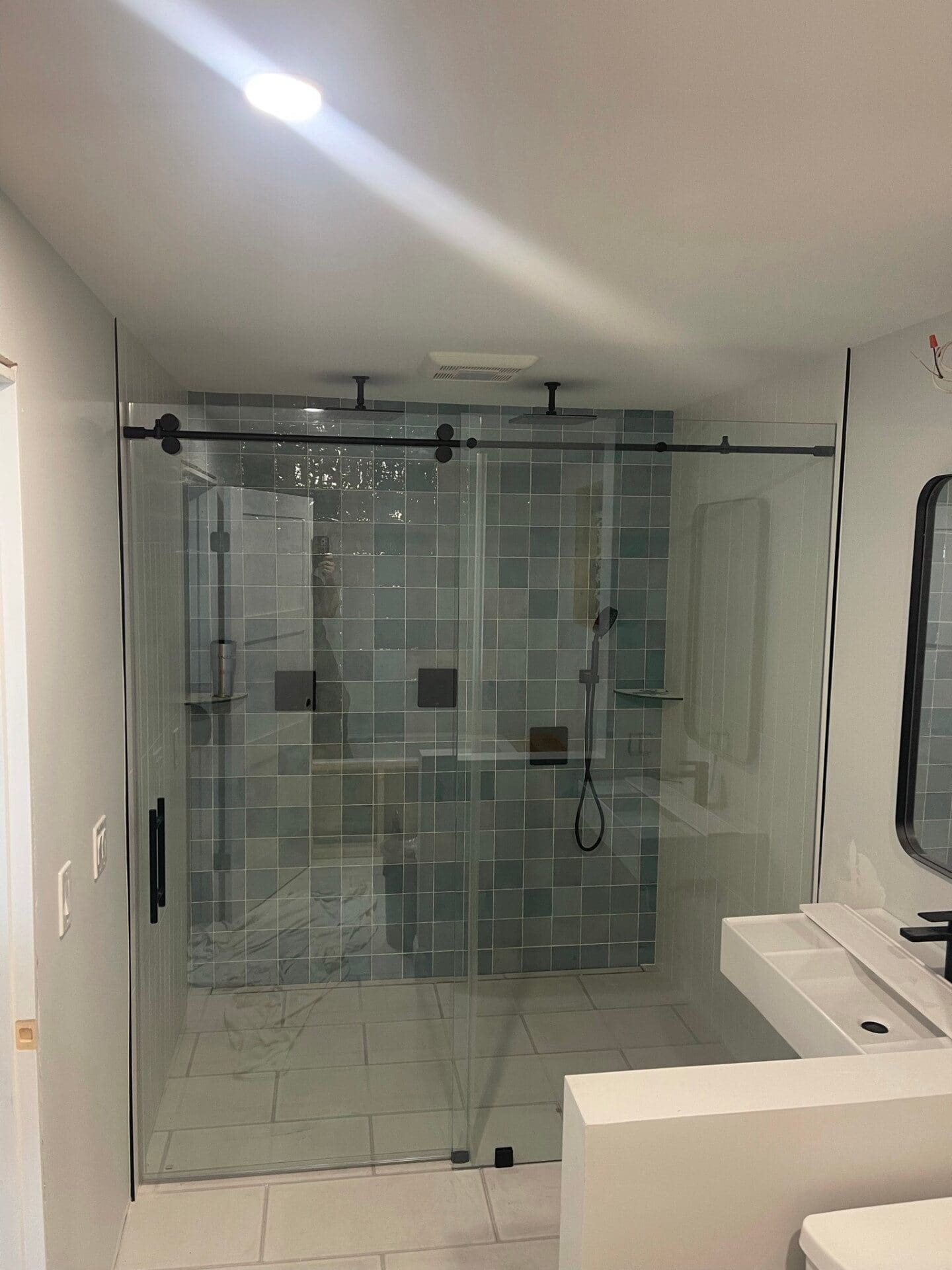 Black sliding barn-style glass shower door installed in Lincoln, RI